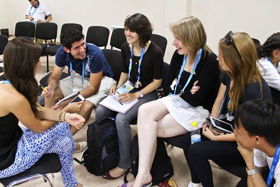 Young reporters working in groups (preparation for a press conference)