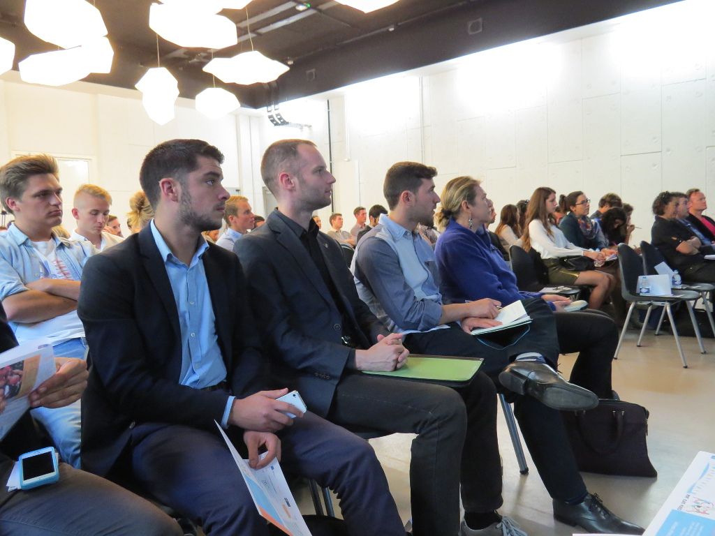 Conference audience with speakers in the first row