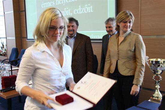 Member of the silver medallist women's water polo team receiving her award